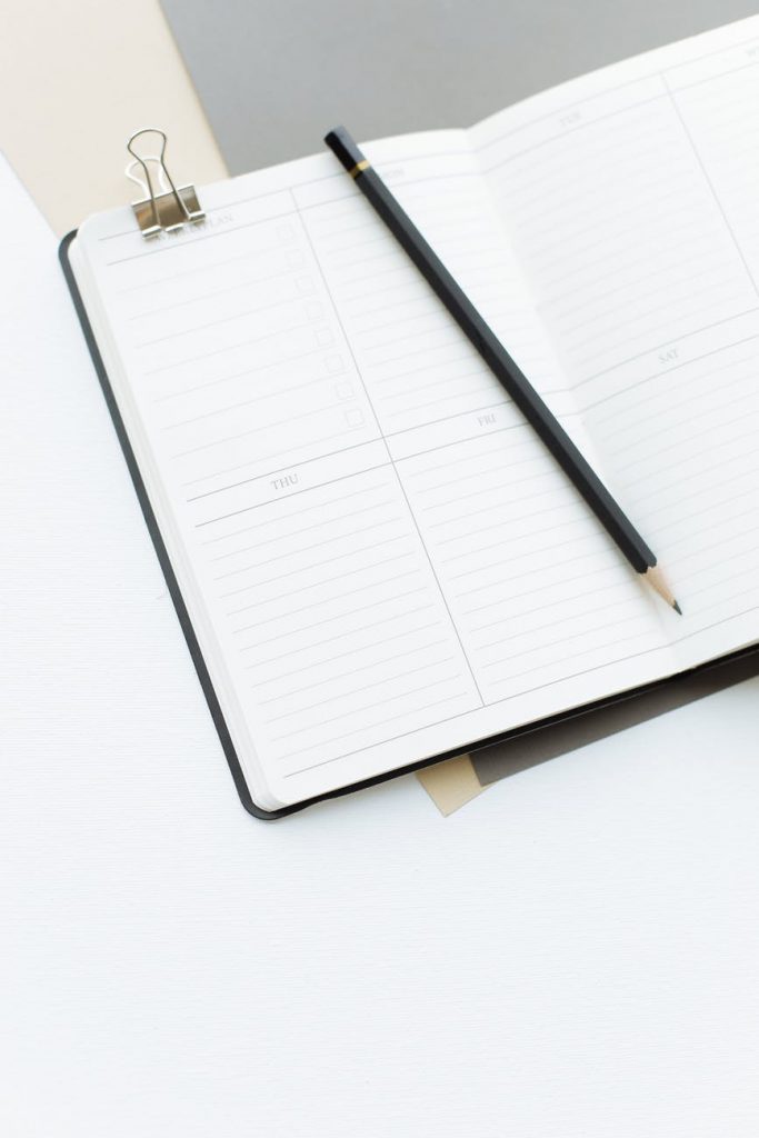opened diary with pencil placed on desk